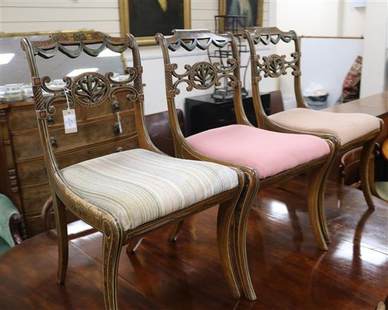 Three painted and decorated Regency dining chairs